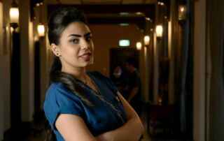 massage therapist standing in salon hallway