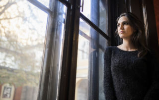 young woman looking out the window