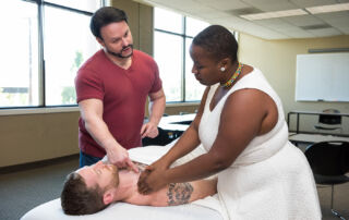 east west college student working in the student massage clinic