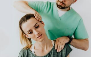 medical massage therapist helping patient